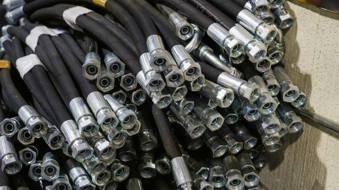 Hundreds of black hydraulic hoses in a corner